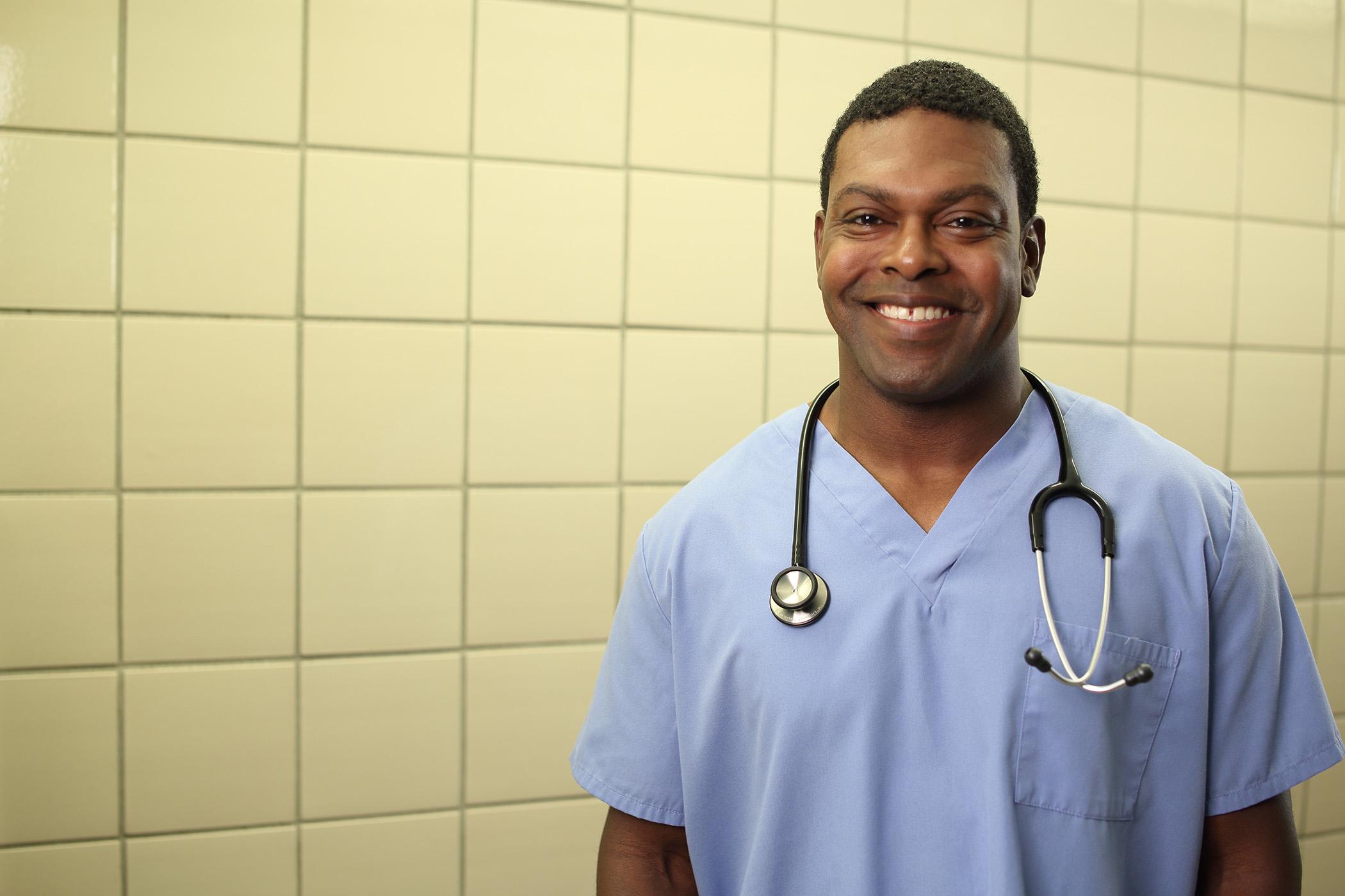 Nursing student in scrubs standing in the hall