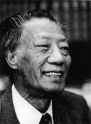 Archival portrait of a  smiling Dr. Chueh Chang in a suit