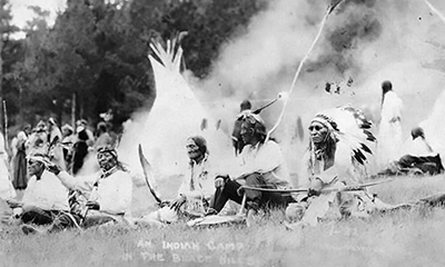 Archival photo of Native Americans at their camp.