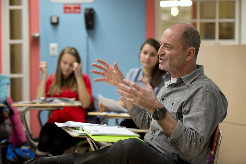 Professor speaking with hands his sustainabilty course