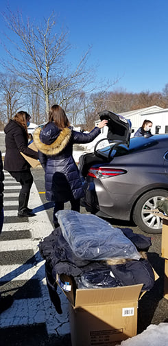volunteers distributing food and coats