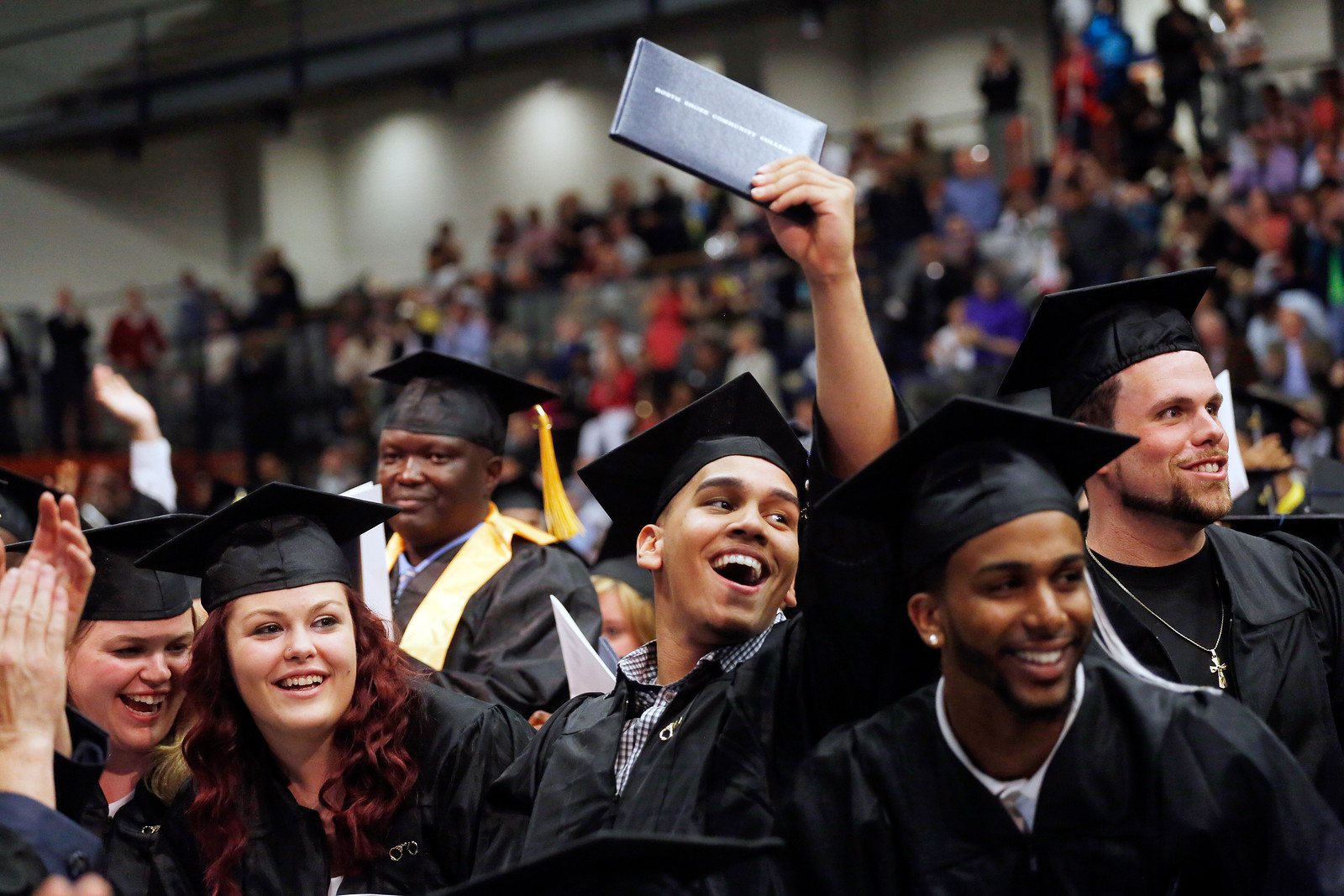 group of happy male and female grads