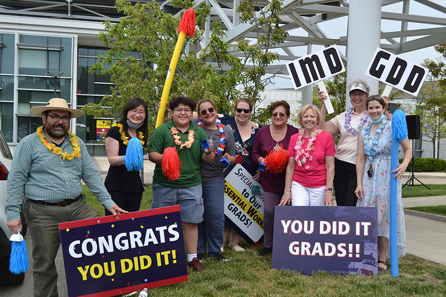 group of celebrators with congratulations signs