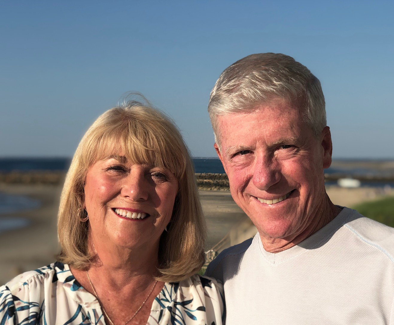 Photo of Donna and Henry Bertolon with tan ocean background