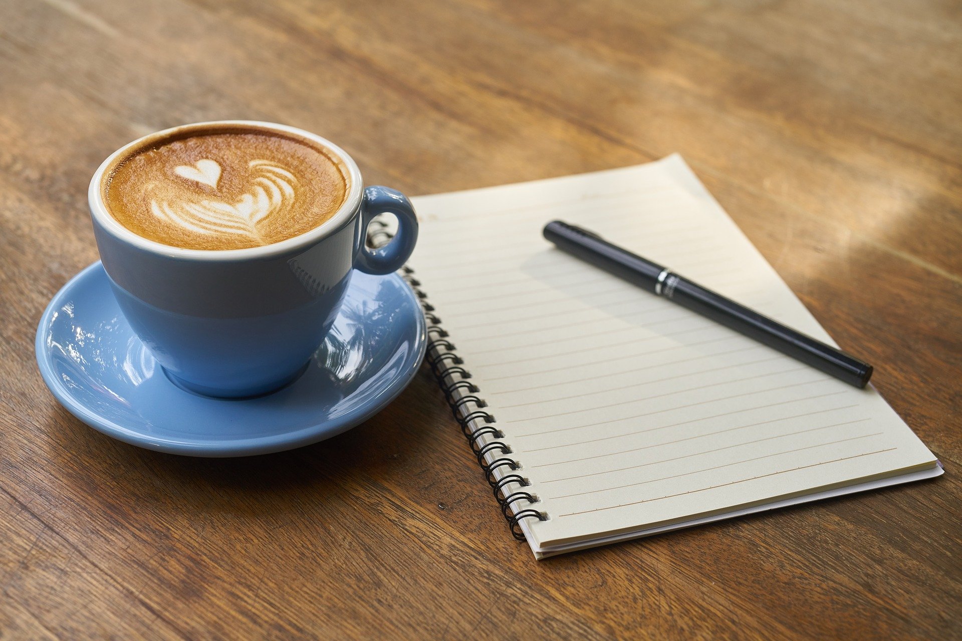 cup of coffee, notebook, pen