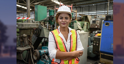 female in hard hat in manufacturing setting