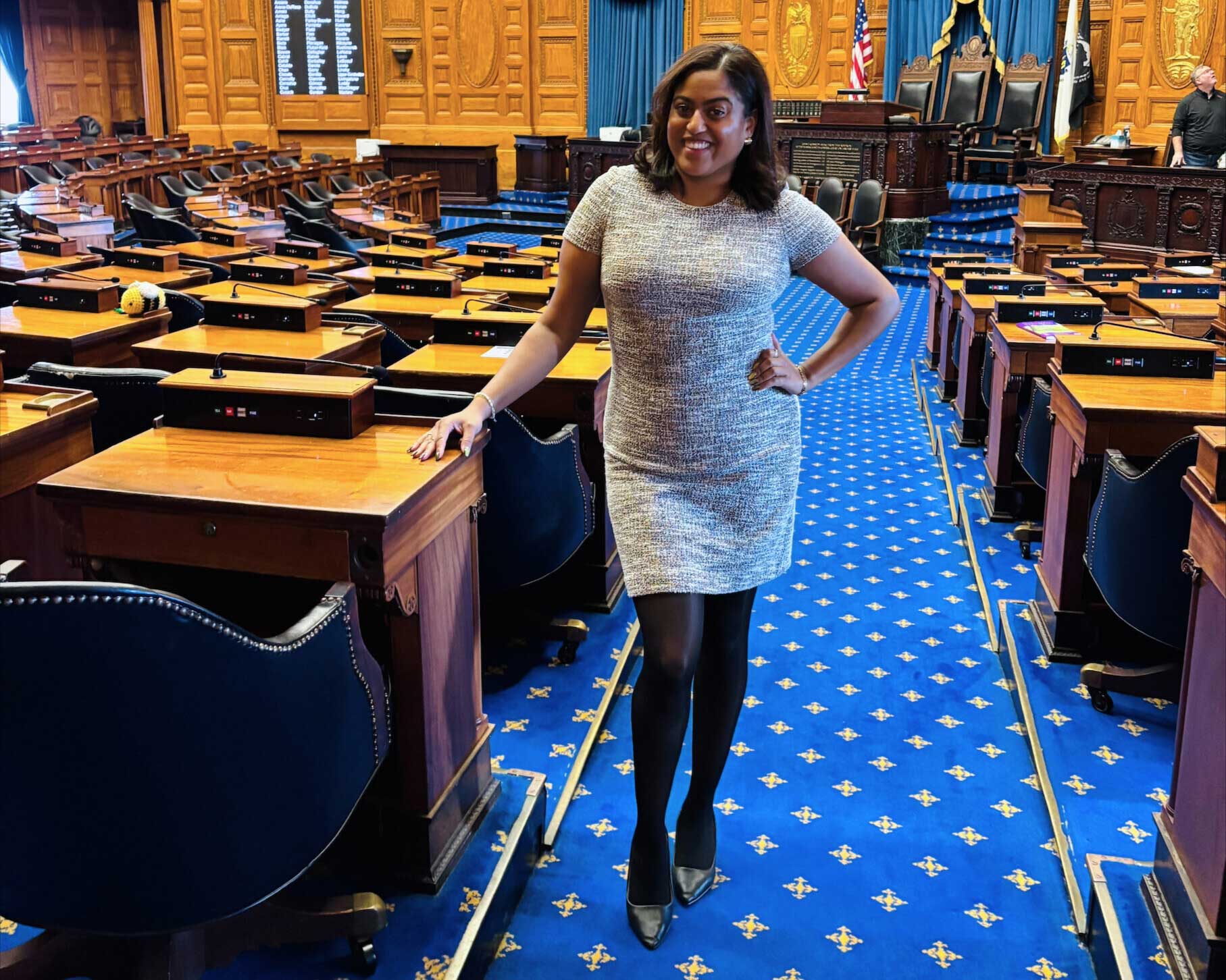 Alexandra Rodriguez stands in the aisle in the House of Representatives