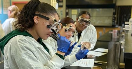 Three Microbiology students examine soil samples