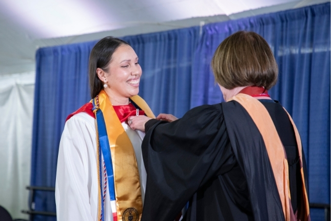 Quezada receivng her pin at the Nurse Education Pinning Ceremony 