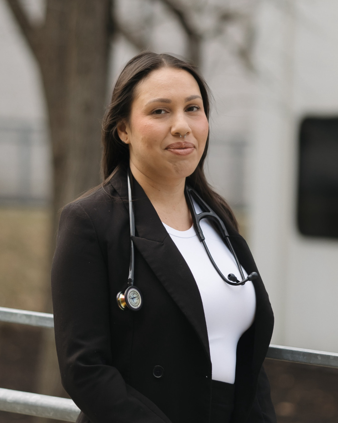 Elizabeth Quezada wearing a blazer and a stethescope
