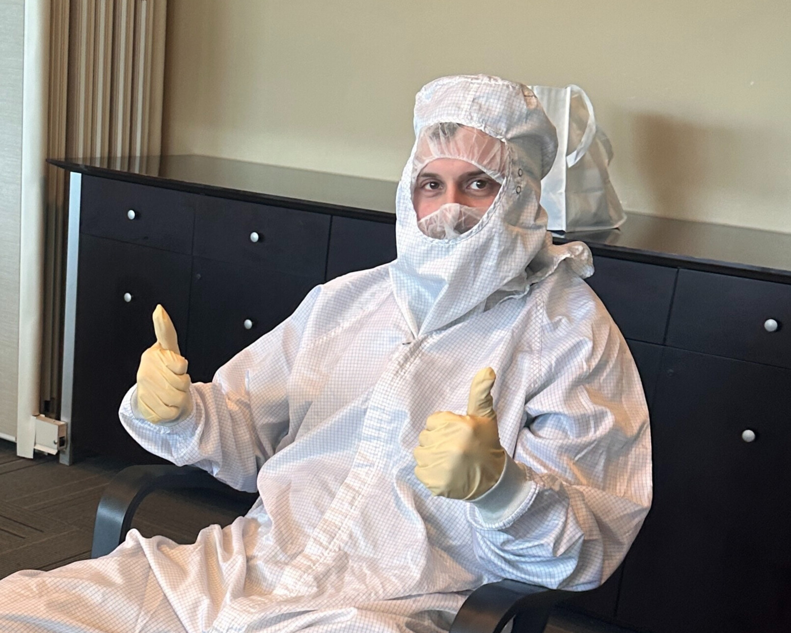 Morehead poses while dressed in a cleanroom suit