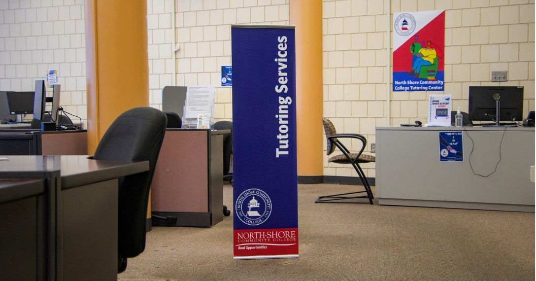 A sign for the Tutoring Center stands in the Lynn Campus computer lab