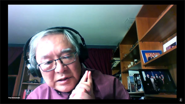 key frame of Dr. Watanabe speaking in his home office.