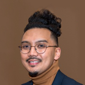 Portrait of Nikki in brown turtleneck on a brown background